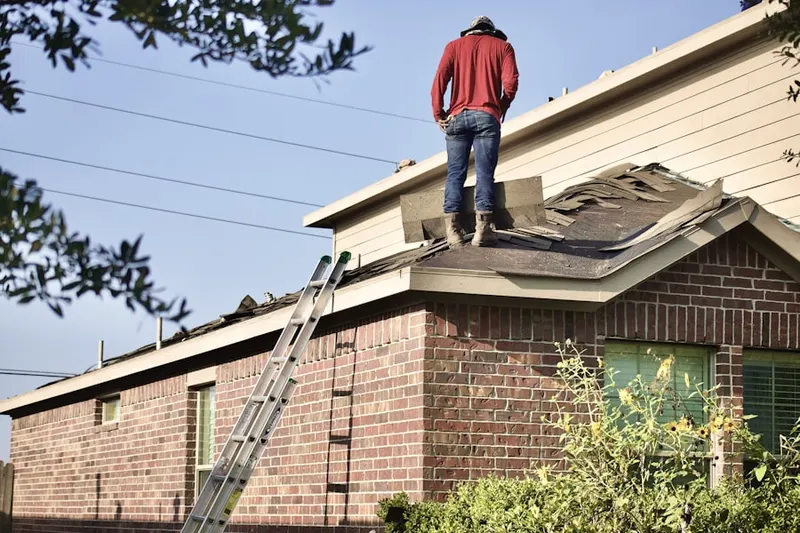 Professional roofer working on a residential roof in Hard Point